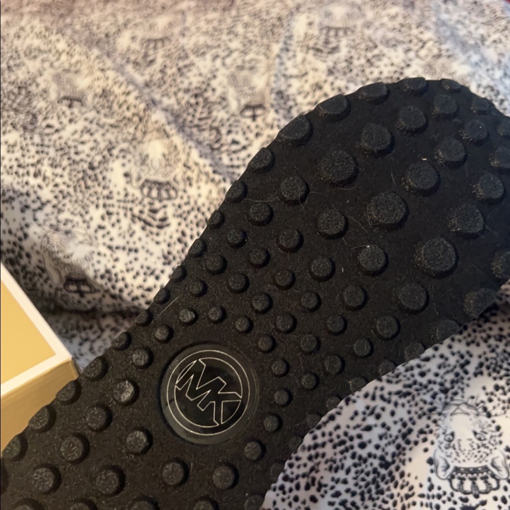 Black with metallic mk logo slip on sneakers